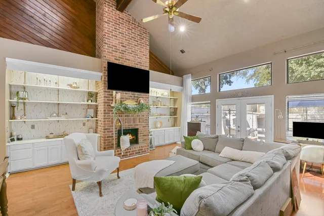 a living room with furniture large window and flat screen tv