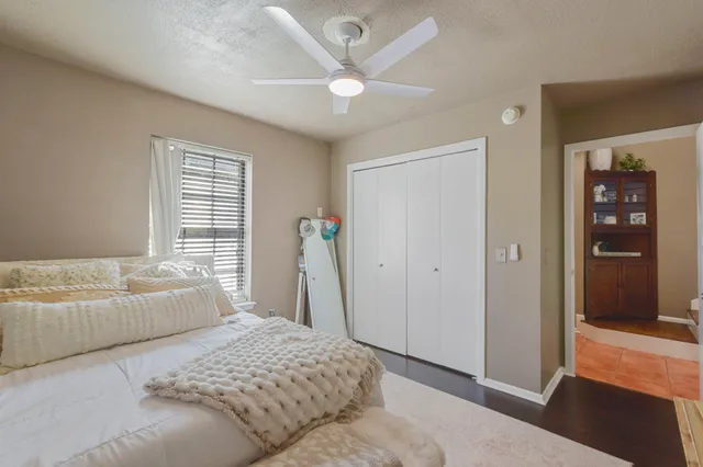 a bedroom with a bed and a large window
