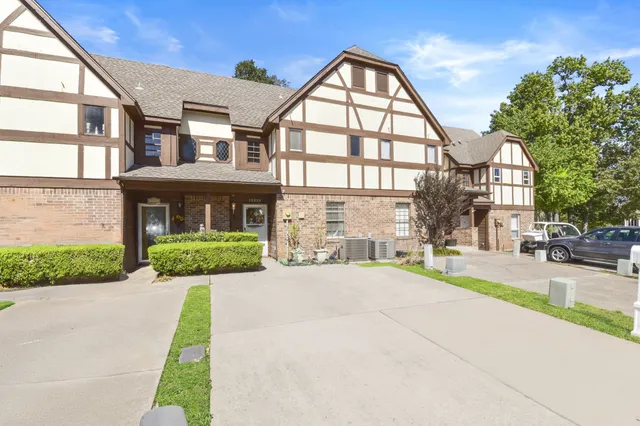a view of a brick building next to a yard
