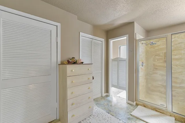 a bathroom with a tub a sink and glass door