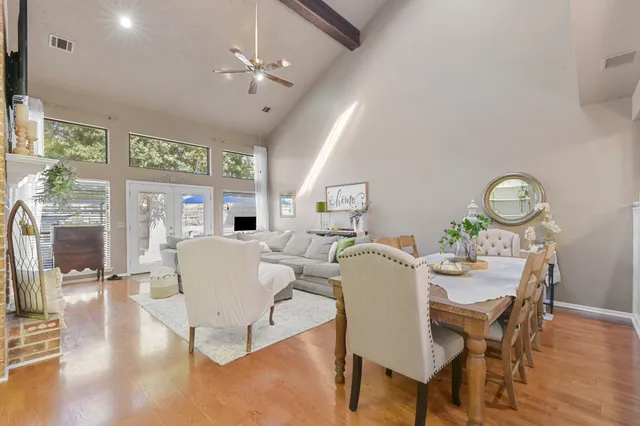 a dining room with furniture a rug and wooden floor