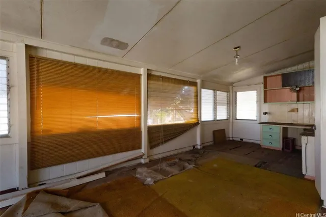 a view of a livingroom with a ceiling fan and window