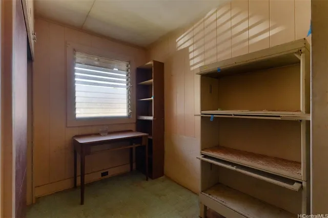 a reading room with wooden floor and furniture
