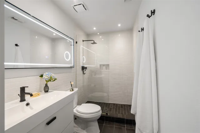 a bedroom with two beds and a chandelier