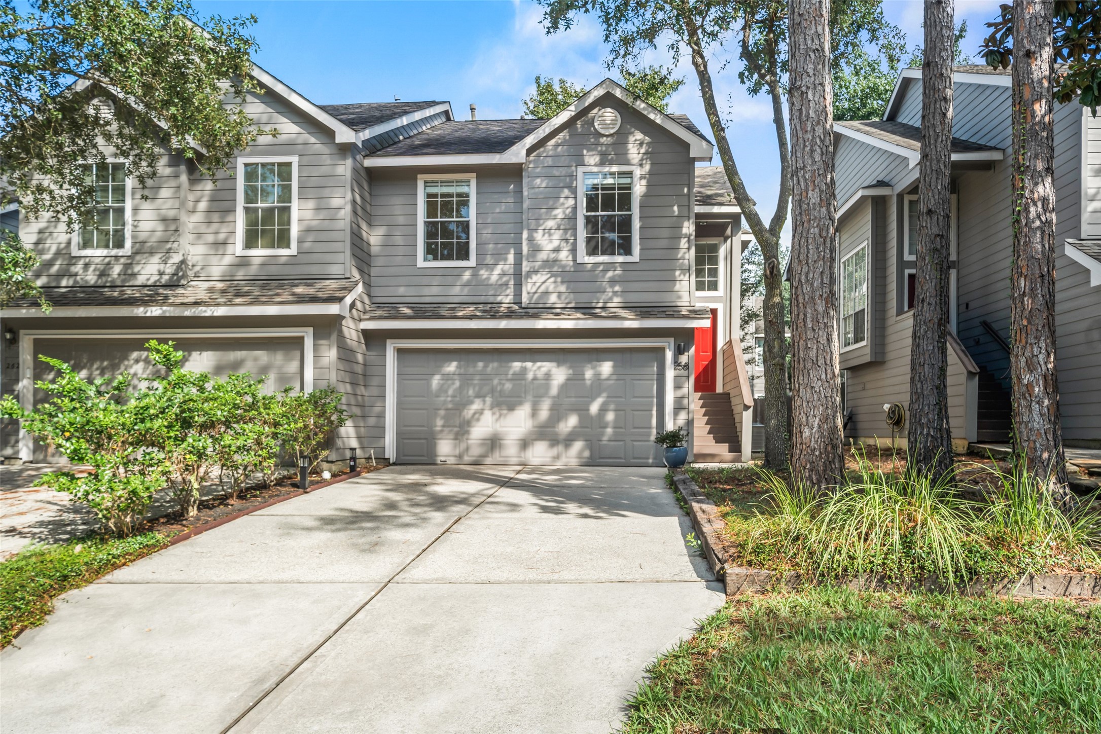 258 Sentry Maple Place The Woodlands, TX 77382 - Photo 2 of 27 a front view of a house with a yard