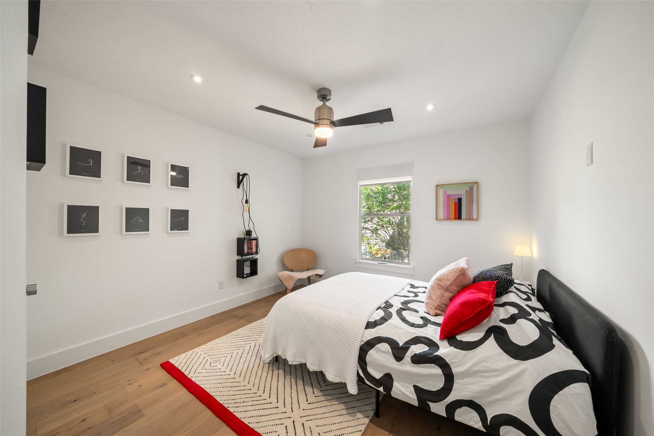 258 Sentry Maple Place The Woodlands, TX 77382 - Photo 21 of 27 a bedroom with a bed and a chandelier