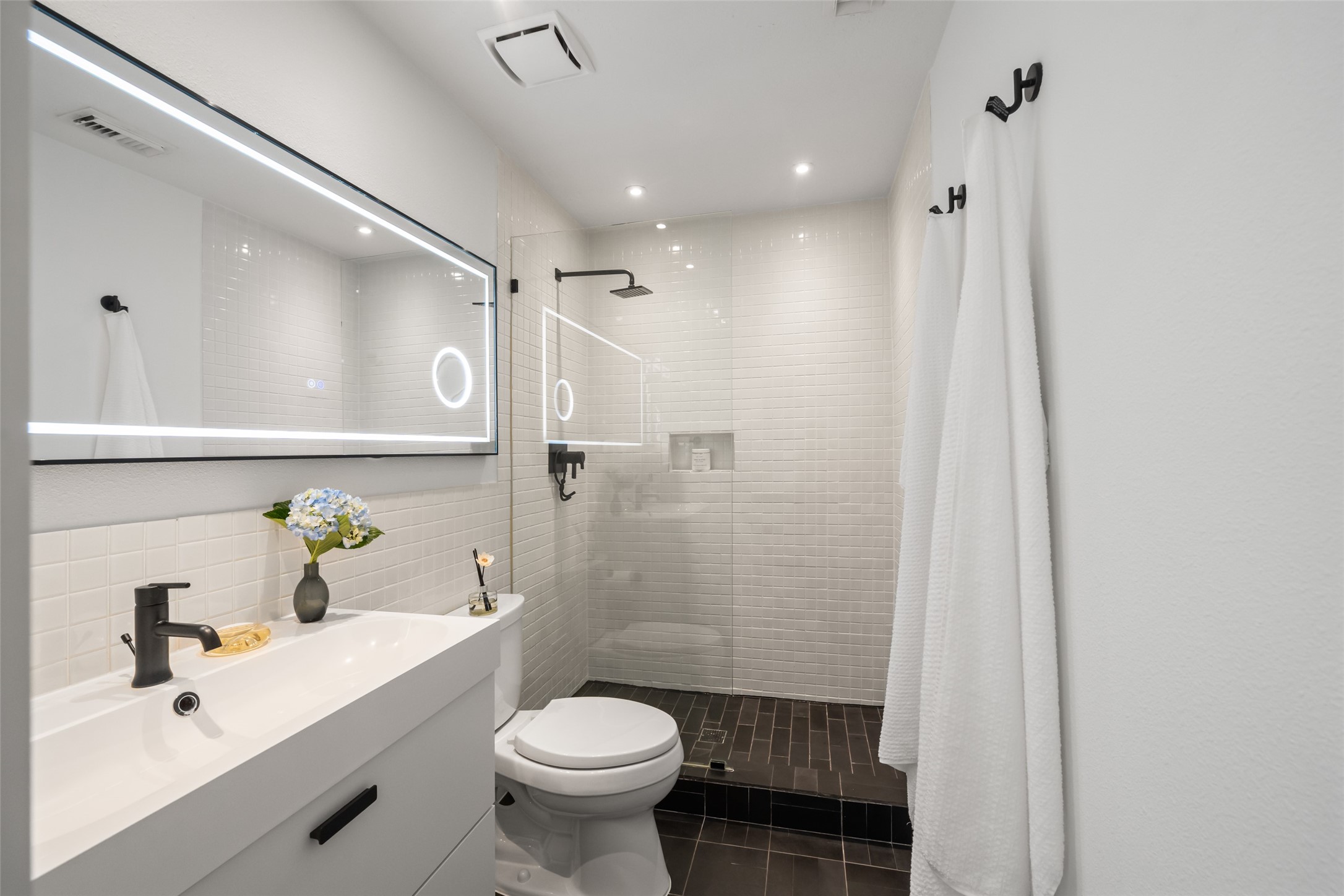 258 Sentry Maple Place The Woodlands, TX 77382 - Photo 22 of 27 a bathroom with a sink a toilet and shower
