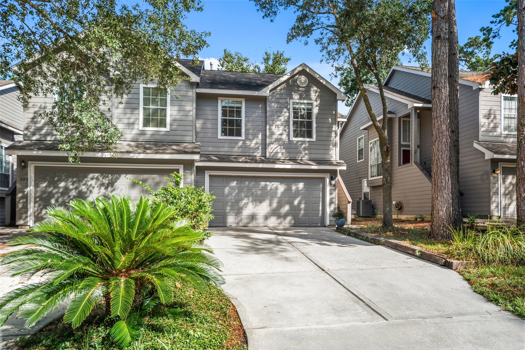 258 Sentry Maple Place The Woodlands, TX 77382 - Photo 27 of 27 a front view of a house with a garden