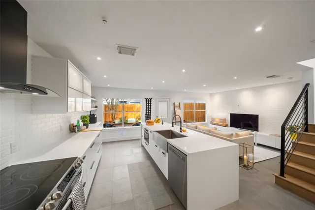 a kitchen with cabinets stainless steel appliances and wooden floor