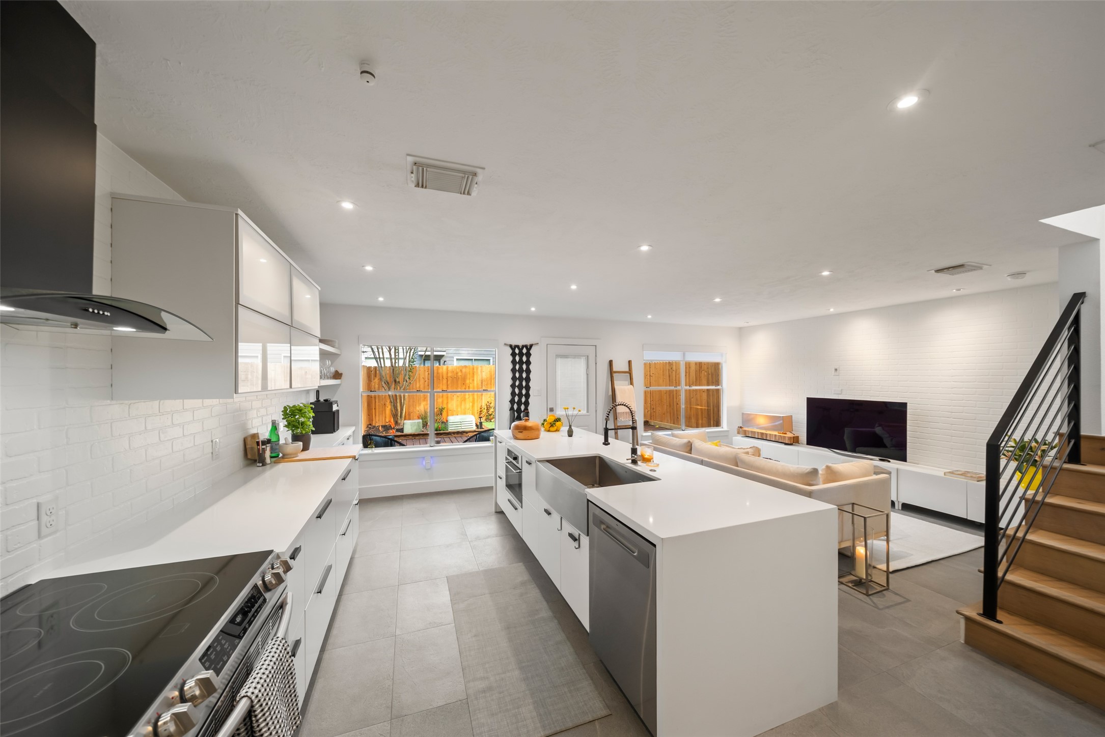 258 Sentry Maple Place The Woodlands, TX 77382 - Photo 8 of 27 a large kitchen with a large counter top appliances and a window