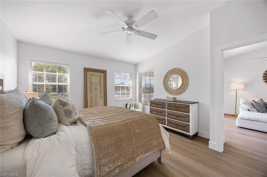 2450 Old Groves Road, Unit 201 Naples, FL 34109 - Photo 14 of 32 a bedroom with a bed and a window