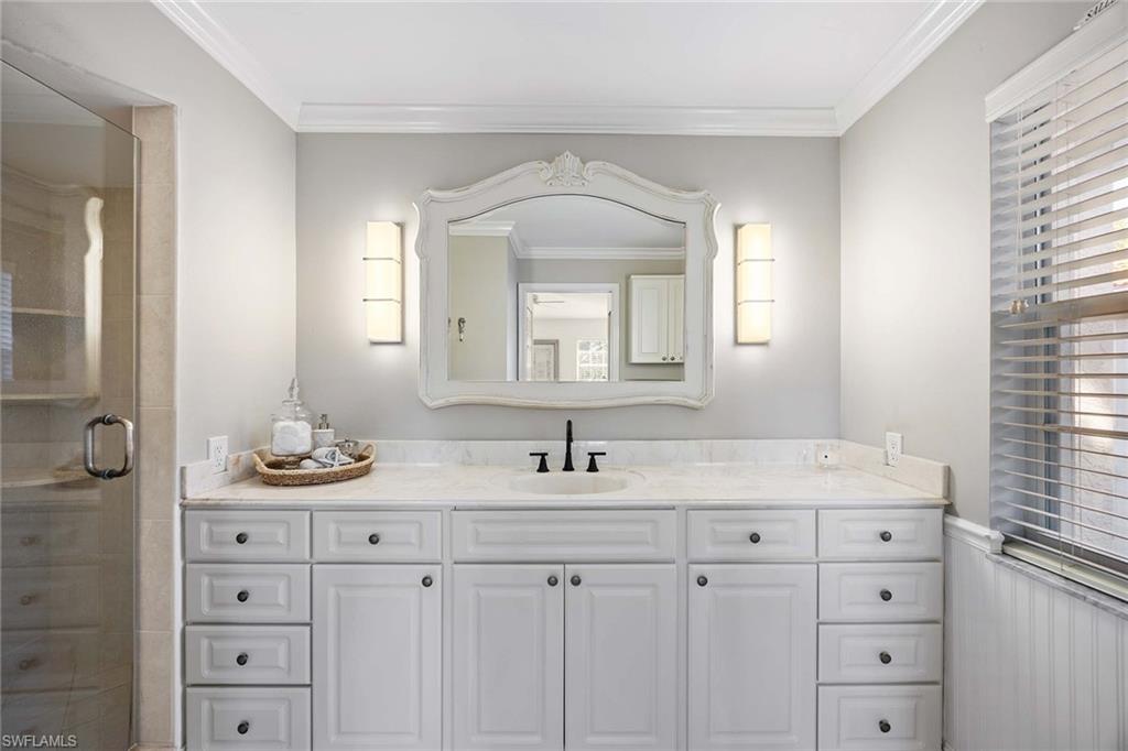 2450 Old Groves Road, Unit 201 Naples, FL 34109 - Photo 15 of 32 a bathroom with double sink and a mirror