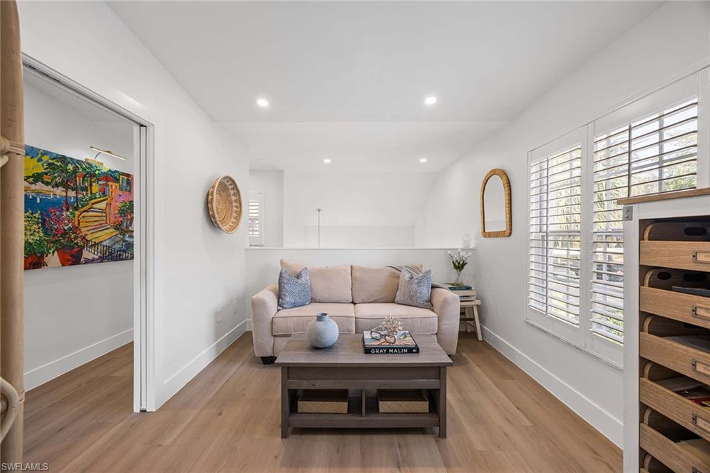 2450 Old Groves Road, Unit 201 Naples, FL 34109 - Photo 19 of 32 a living room with furniture and a gate