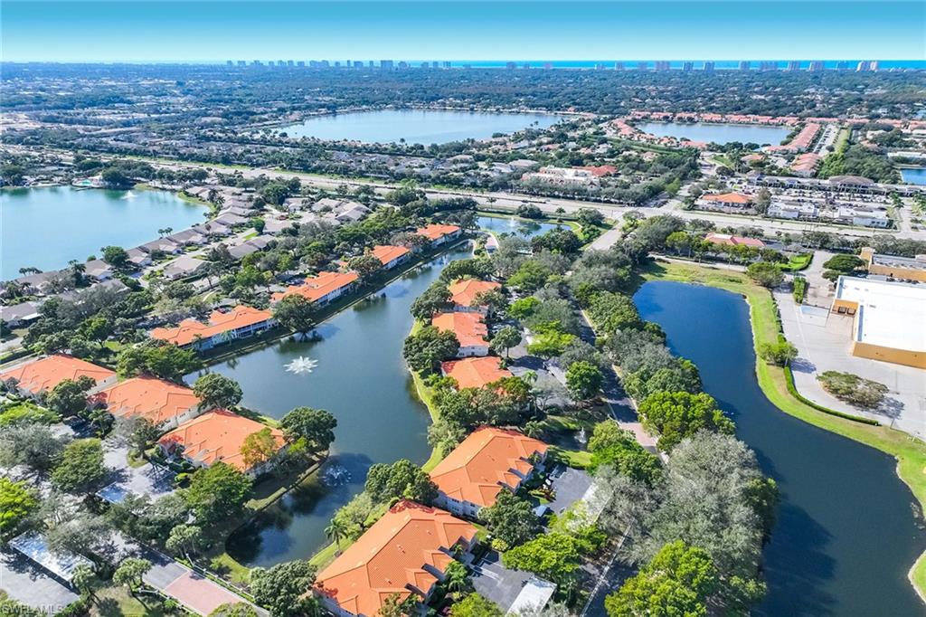 2450 Old Groves Road, Unit 201 Naples, FL 34109 - Photo 30 of 32 an aerial view of residential houses with outdoor space