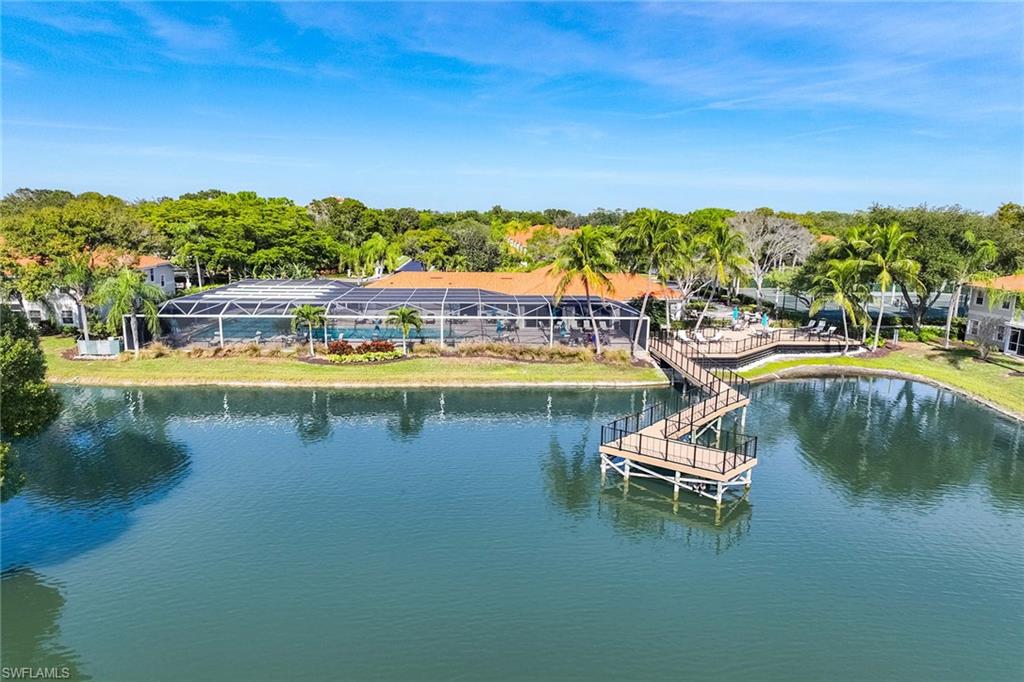 2450 Old Groves Road, Unit 201 Naples, FL 34109 - Photo 32 of 32 a view of a lake with boats and trees in the background