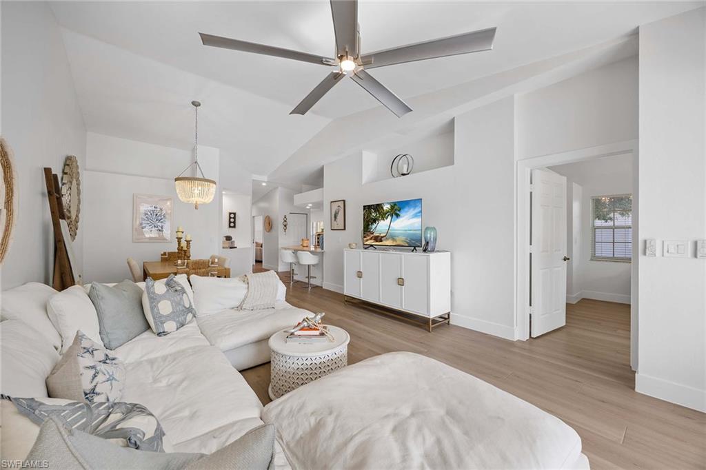2450 Old Groves Road, Unit 201 Naples, FL 34109 - Photo 6 of 32 a living room with furniture and wooden floor