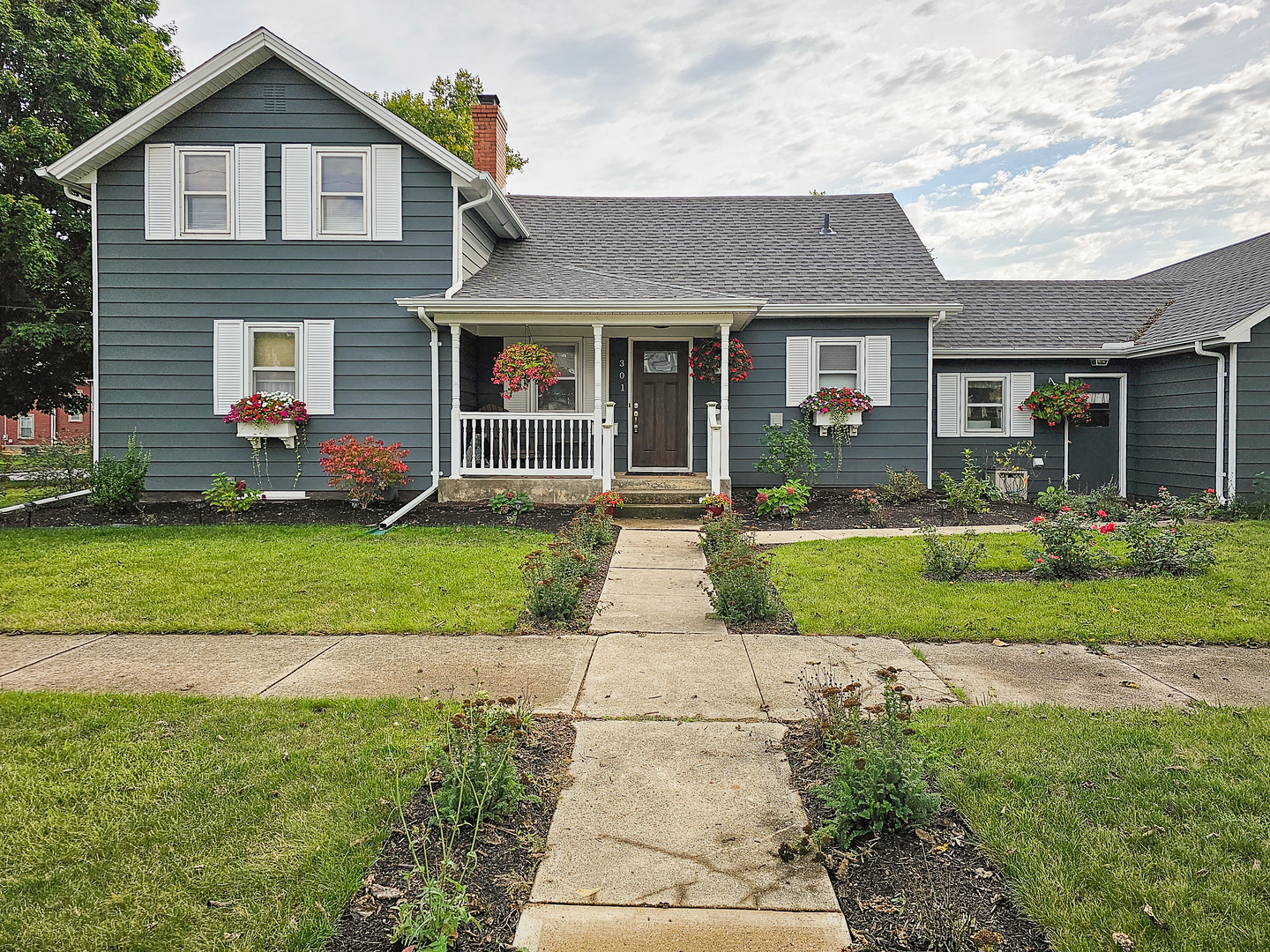 301 Adams Street Oregon, IL 61061 - Photo 2 of 50 a front view of a house with a yard