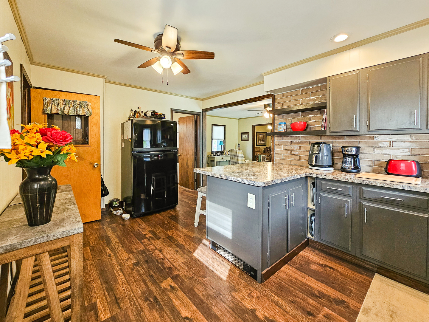 301 Adams Street Oregon, IL 61061 - Photo 21 of 50 a kitchen with kitchen island granite countertop a sink cabinets and stainless steel appliances