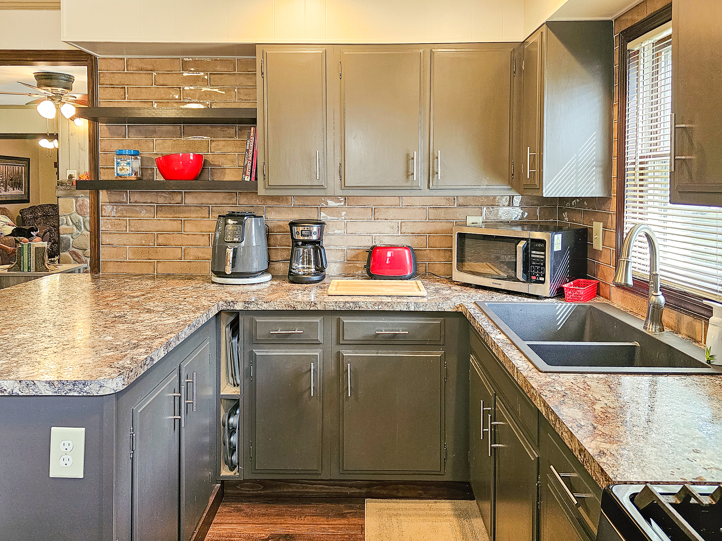 301 Adams Street Oregon, IL 61061 - Photo 23 of 50 a kitchen with stainless steel appliances granite countertop a sink dishwasher and cabinets with wooden floor