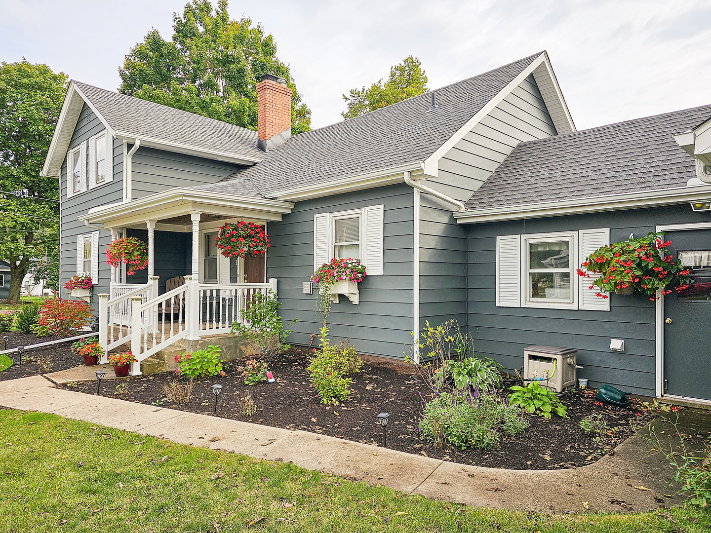 301 Adams Street Oregon, IL 61061 - Photo 3 of 50 a front view of a house with garden