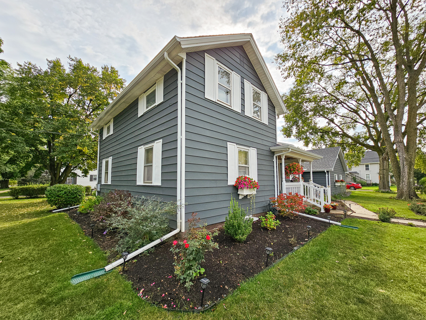 301 Adams Street Oregon, IL 61061 - Photo 37 of 50 a front view of a house with a yard and outdoor seating