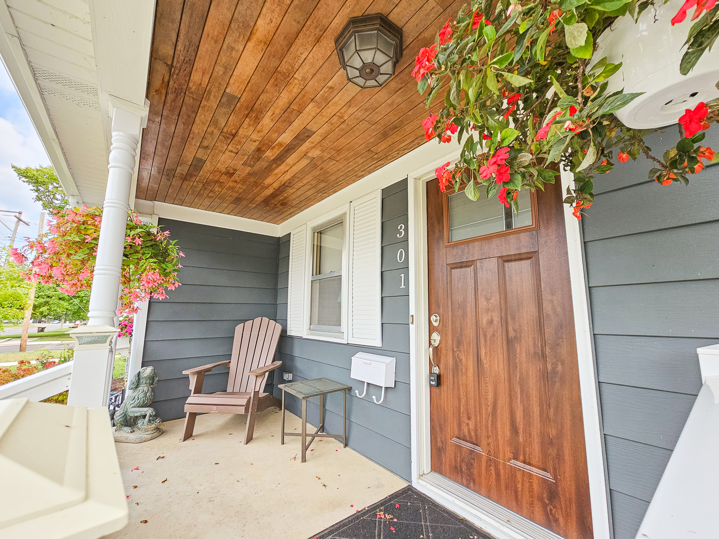 301 Adams Street Oregon, IL 61061 - Photo 5 of 50 a front view of a house with outdoor seating and wooden floor