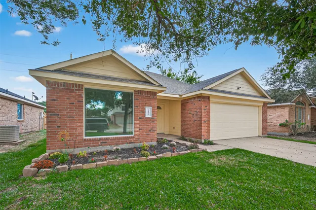 a front view of a house with a garden and yard