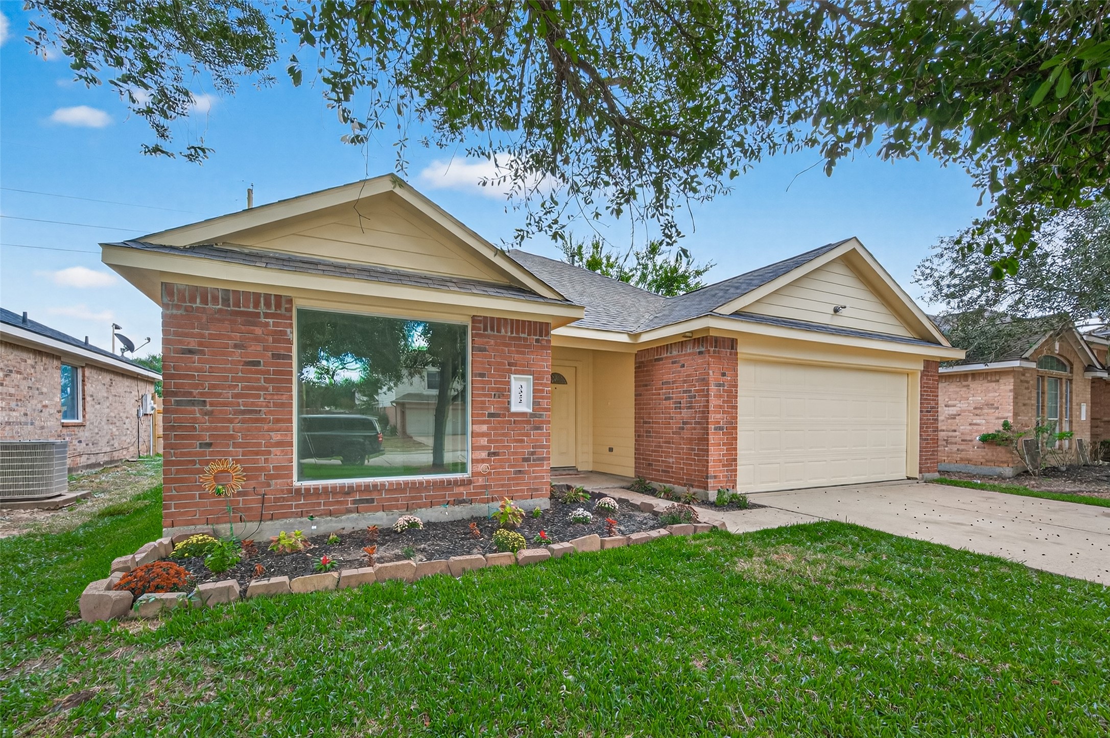 a front view of a house with a garden and yard