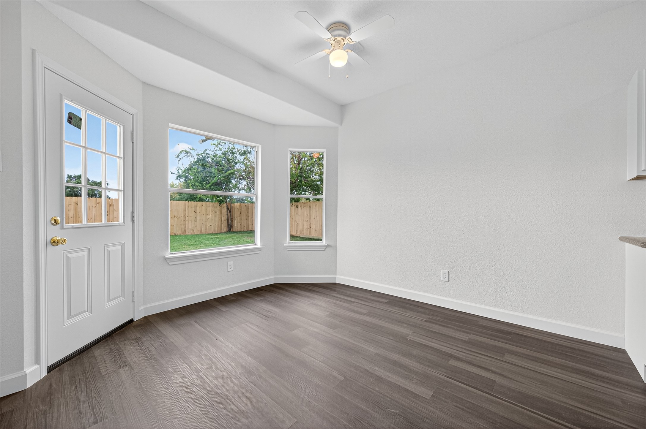 3322 Brackenfern Road Katy, TX 77449 - Photo 12 of 38 an empty room with wooden floor and windows