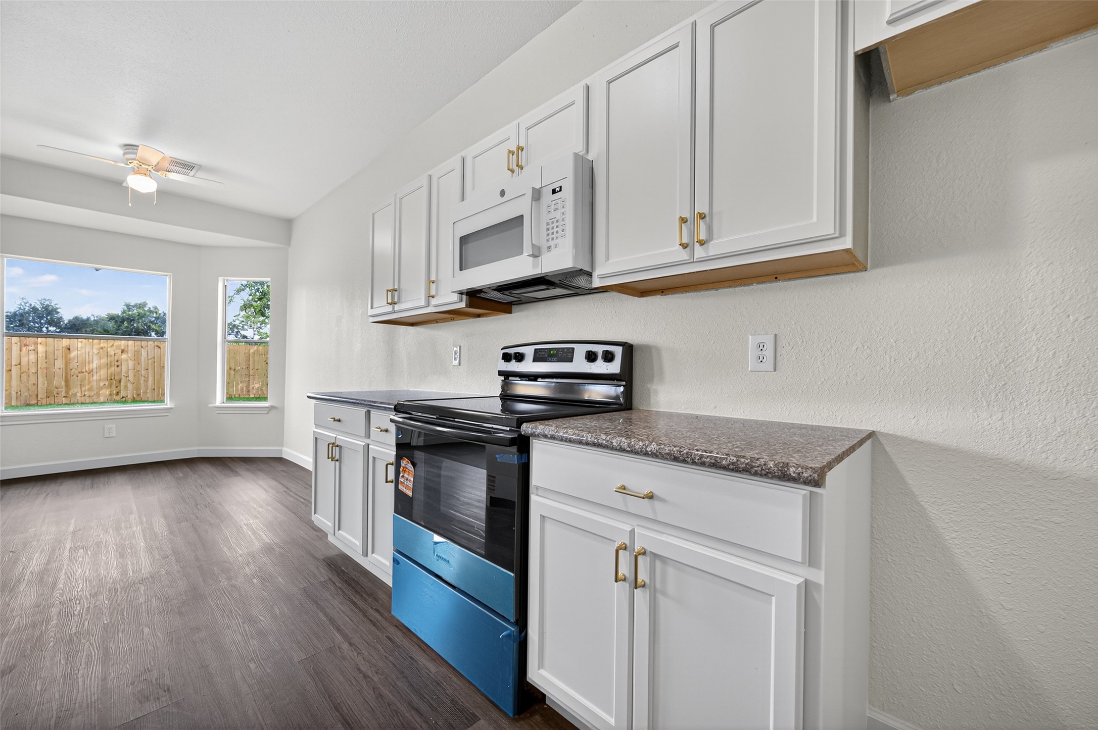 3322 Brackenfern Road Katy, TX 77449 - Photo 17 of 38 a kitchen with appliances cabinets and a wooden floor