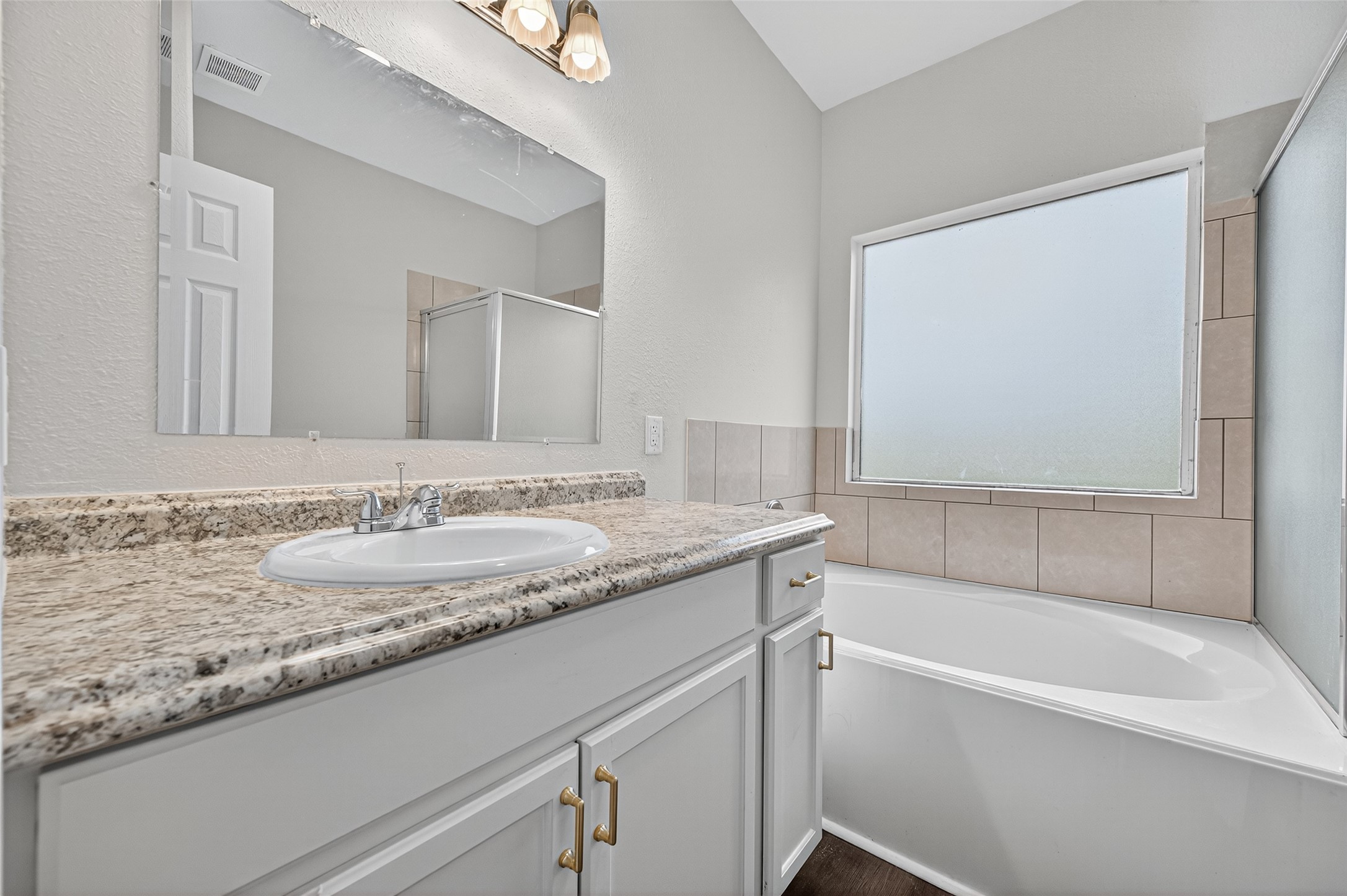 3322 Brackenfern Road Katy, TX 77449 - Photo 32 of 38 a bathroom with a granite countertop bathtub sink vanity and mirror