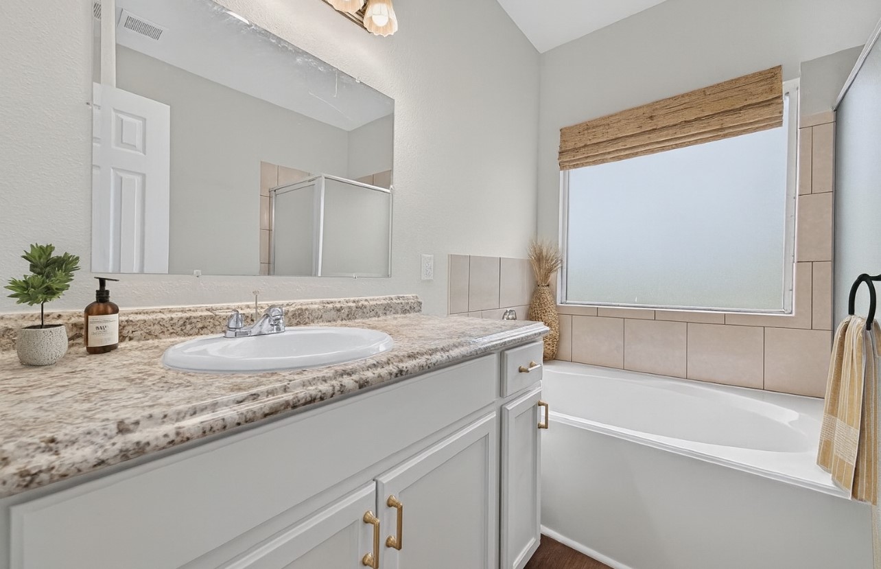 3322 Brackenfern Road Katy, TX 77449 - Photo 33 of 38 a bathroom with a granite countertop sink and a mirror