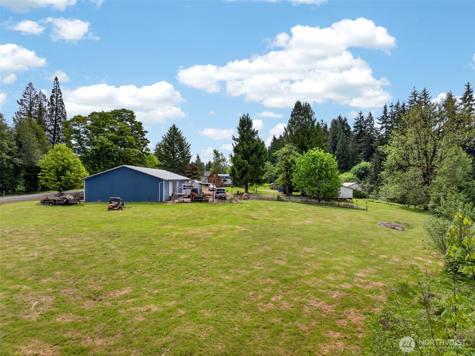 943 Fall Creek Road Longview, WA 98632 - Photo 36 of 40 a yellow house with a big yard and large trees