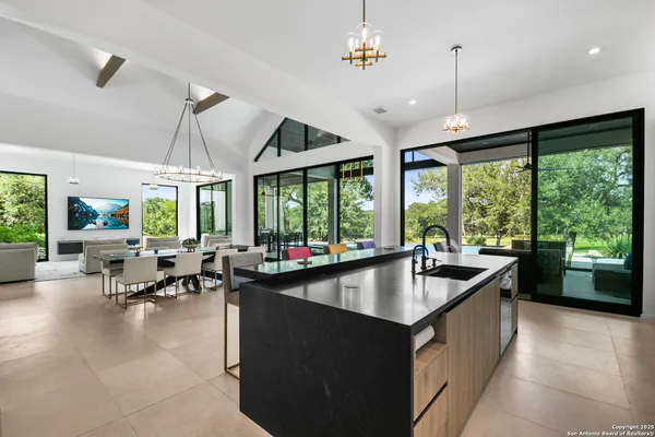 a living room with patio furniture and a large window