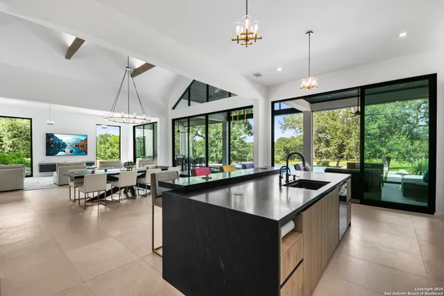 a living room with patio furniture and a large window
