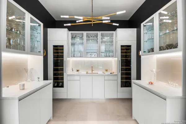 a kitchen with stainless steel appliances kitchen island granite countertop a refrigerator and a sink