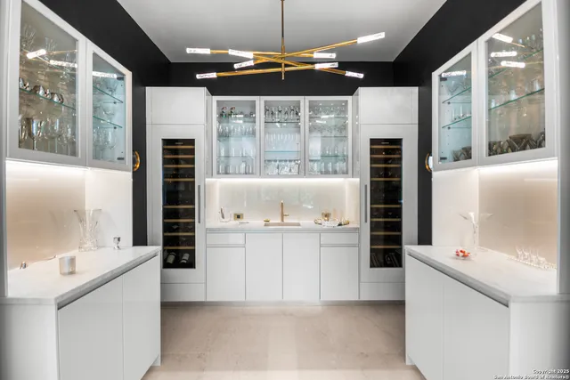 a kitchen with stainless steel appliances kitchen island granite countertop a refrigerator and a sink