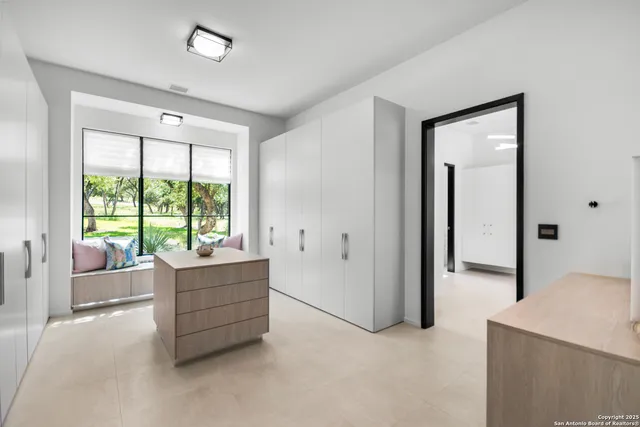 a living room with furniture and large windows