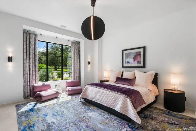 a spacious bedroom with a bed a couch and a window