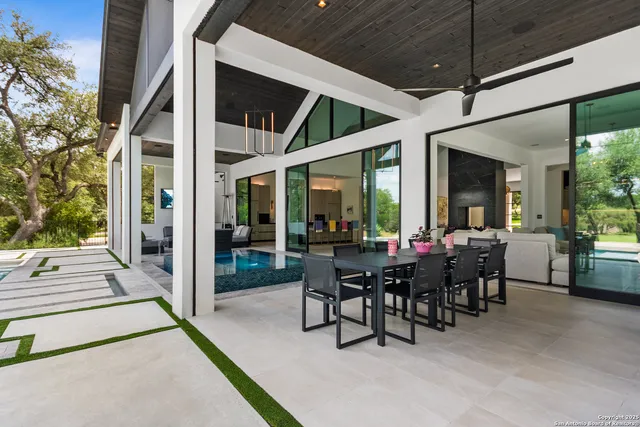 a view of a dining room with furniture and front view of a house