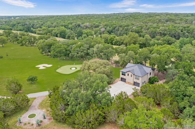 an aerial view of a house with a yard