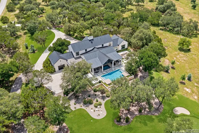 an aerial view of a house with garden space and street view