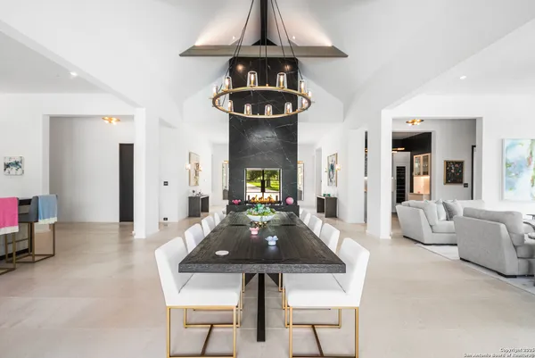 a living room with furniture and chandelier