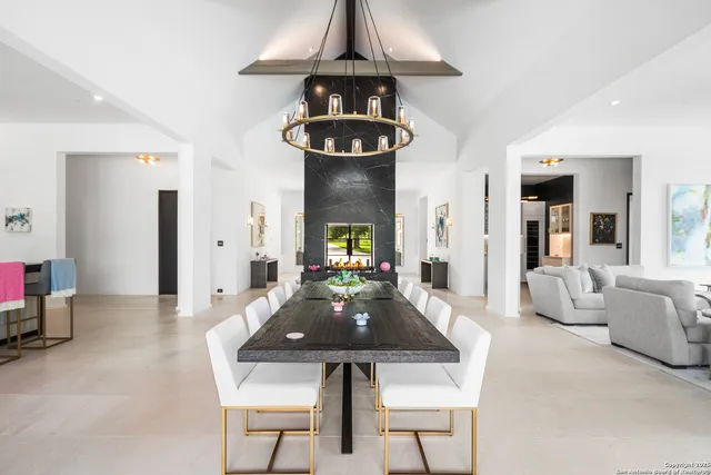 a living room with furniture and chandelier
