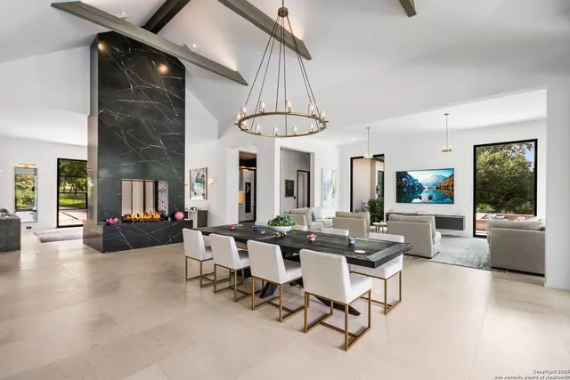 a living room with furniture a window and potted plants
