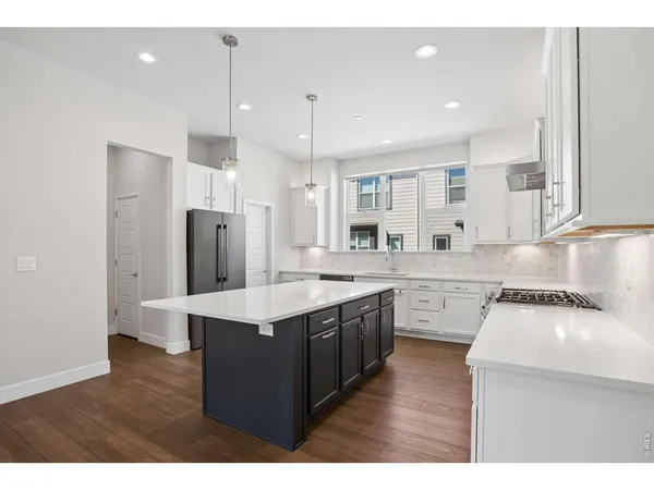 a view of kitchen with cabinets and wooden floor
