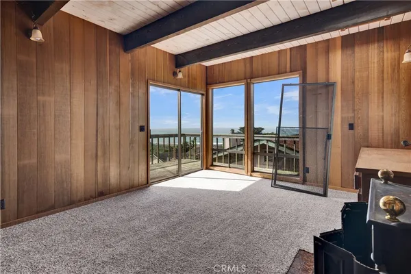 a view of a room with furniture and floor to ceiling window