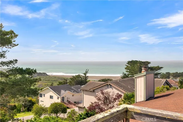 a view of a terrace with lawn chairs