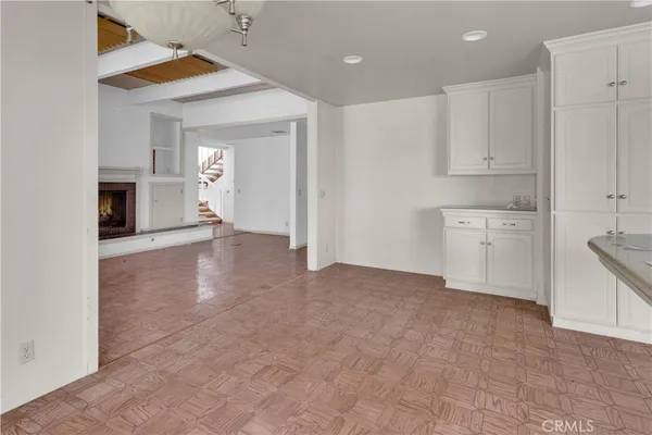 a view of an empty room with a kitchen