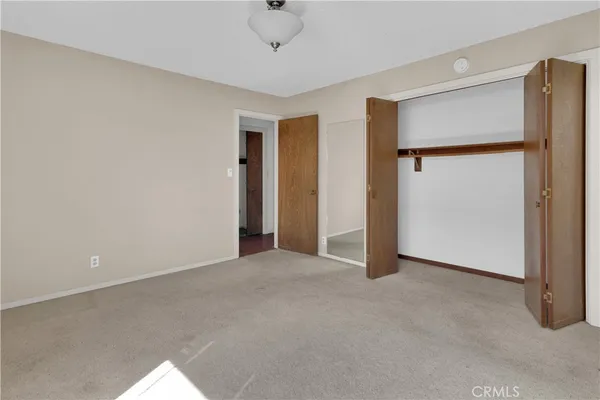 an empty room with closet area